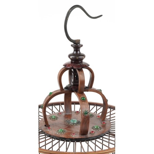 628 - Chinese hardwood hanging birdcage with green and red cabochons, 65cm high