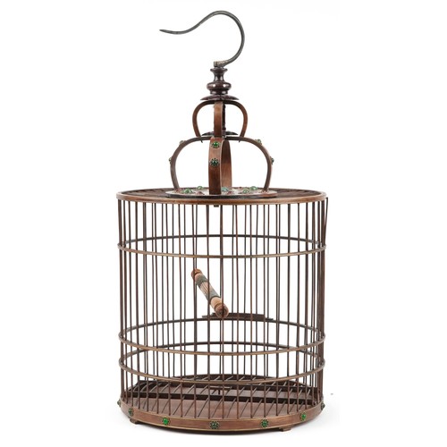 628 - Chinese hardwood hanging birdcage with green and red cabochons, 65cm high