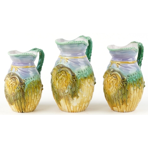 1312 - Graduated set of three Majolica jugs, each decorated in relief with a ram's head, the largest 22.5cm... 