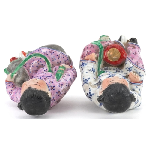 1318 - Pair of Chinese porcelain figures of children wearing robes, the largest 9.5cm high