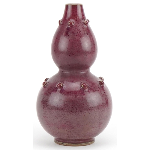 412 - Chinese porcelain double gourd vase having a red glaze, 25cm high