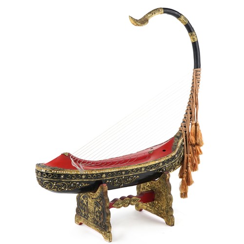 1455 - Large Burmese black and red lacquered Saung-gauk harp on stand, each gilt decorated in low relief wi... 