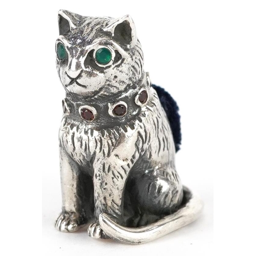 307 - Sterling silver pincushion in the form of a seated cat set with emerald eyes and garnet collar, 2.6c... 