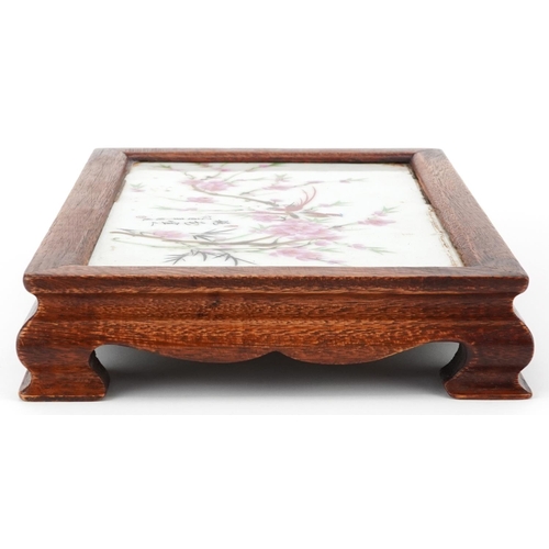 1445 - Chinese hardwood stand housing a porcelain panel decorated with birds amongst flowers, signed with c... 