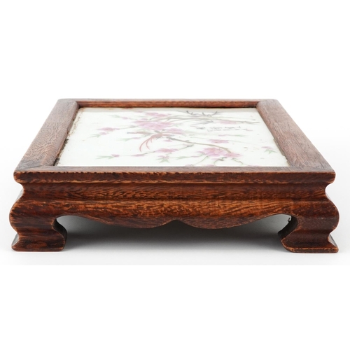 1445 - Chinese hardwood stand housing a porcelain panel decorated with birds amongst flowers, signed with c... 