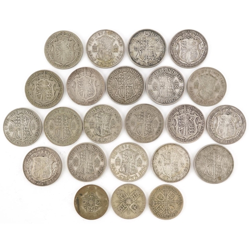 2097 - Twenty George V and later half crowns and three florins, 310g