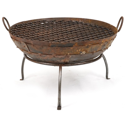 1215 - Cast metal firepit with twin handles and grill on tripod stand, 50cm high x 90.5cm in diameter