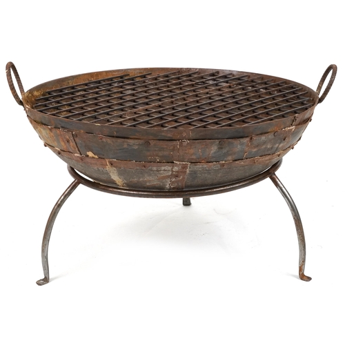 1215 - Cast metal firepit with twin handles and grill on tripod stand, 50cm high x 90.5cm in diameter