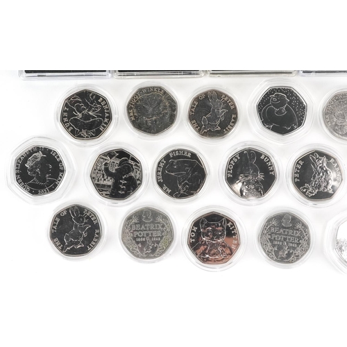 2188 - Thirty two Elizabeth II fifty pence pieces, various designs comprising Beatrix Potter, The Snowman a... 