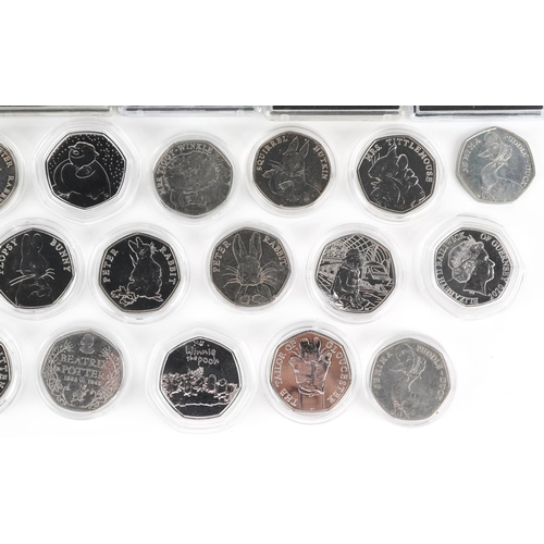 2188 - Thirty two Elizabeth II fifty pence pieces, various designs comprising Beatrix Potter, The Snowman a... 