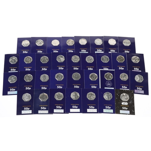 2187 - Thirty three Elizabeth II fifty pence pieces housed in Change Checker sleeves, various designs inclu... 