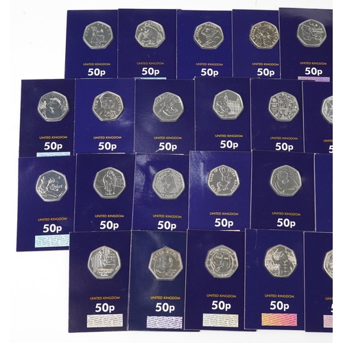 2187 - Thirty three Elizabeth II fifty pence pieces housed in Change Checker sleeves, various designs inclu... 