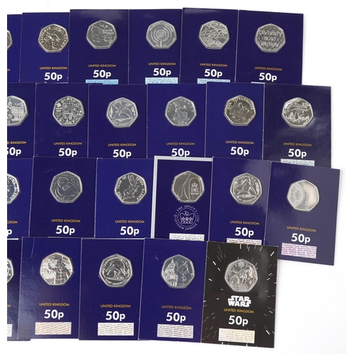 2187 - Thirty three Elizabeth II fifty pence pieces housed in Change Checker sleeves, various designs inclu... 