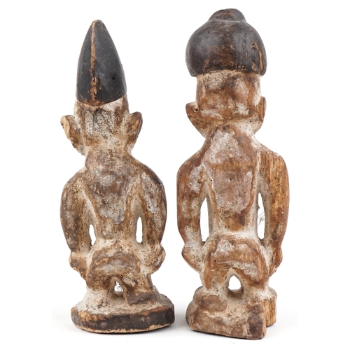 297 - Pair of African tribal interest carved wood figures, the largest 30.5cm high