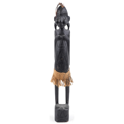 1268 - Large African tribal interest carved wood figure of a tribesman, 63cm high