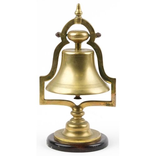 19th/20th century railwayana interest brass railroad bell raised on a circular mahogany base, 34cm high