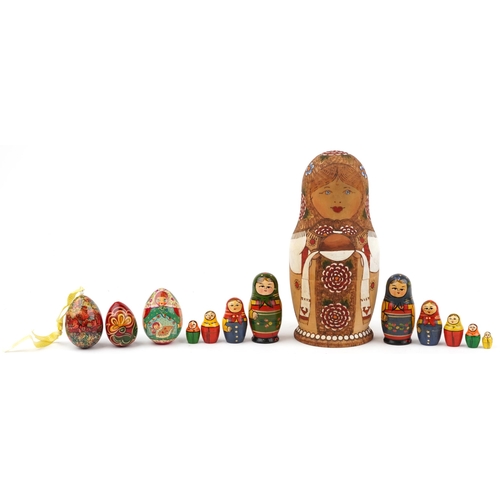 1273 - Three Russian Matryoshka stacking dolls and three lacquered eggs, the largest stacking doll hand pai... 