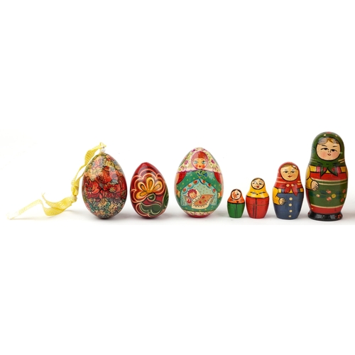 1273 - Three Russian Matryoshka stacking dolls and three lacquered eggs, the largest stacking doll hand pai... 