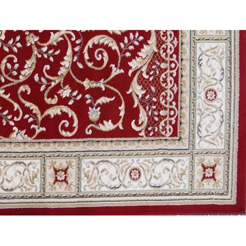 1225 - Rectangular red and cream ground floral rug, 230cm x 160cm