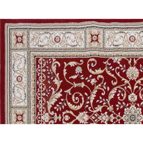 1225 - Rectangular red and cream ground floral rug, 230cm x 160cm