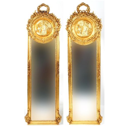 1233 - Matched pair of French Empire style ornate gilt framed wall mirrors with wreath crests and bevelled ... 