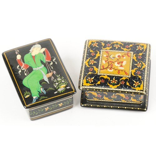 1481 - Two Islamic black lacquered boxes and covers including an example hand painted with flowers, the lar... 