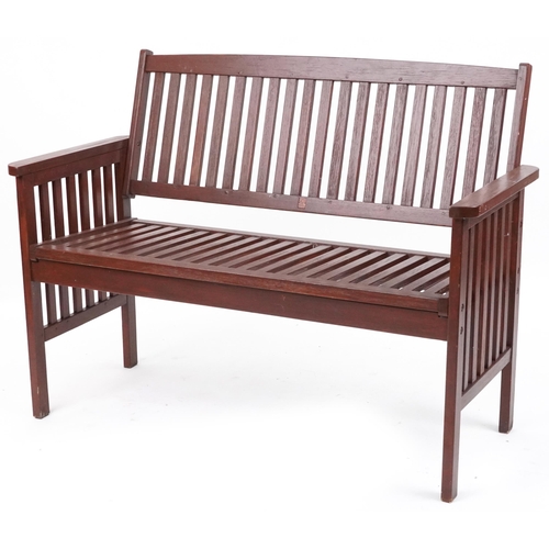 1185 - Stained teak slatted garden bench, 89cm H x 118.5cm W x 58cm D