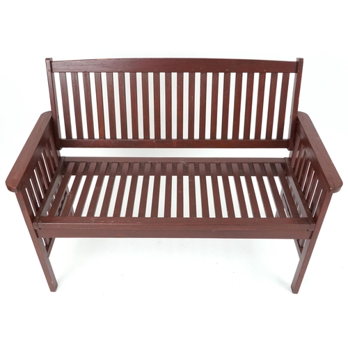 1185 - Stained teak slatted garden bench, 89cm H x 118.5cm W x 58cm D