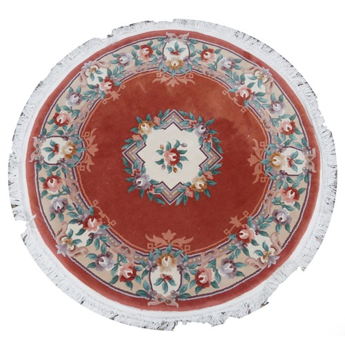 1226 - Four Chinese floral rugs comprising two circular and an oval example, the largest 167cm in diameter