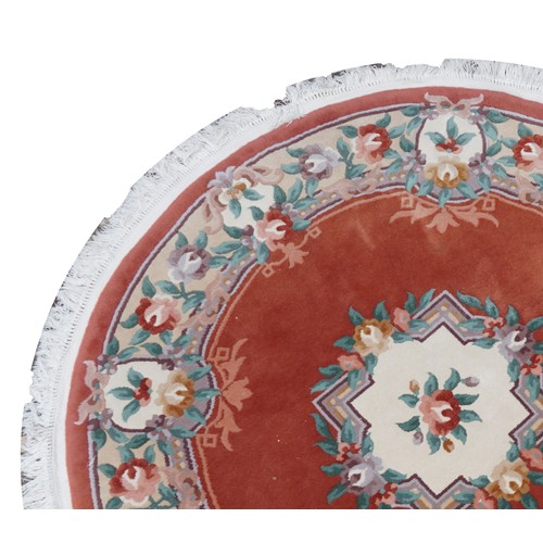 1226 - Four Chinese floral rugs comprising two circular and an oval example, the largest 167cm in diameter