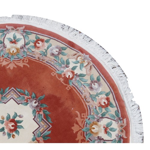 1226 - Four Chinese floral rugs comprising two circular and an oval example, the largest 167cm in diameter