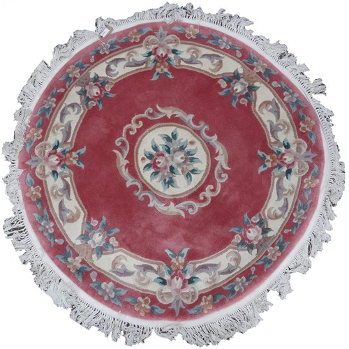 1226 - Four Chinese floral rugs comprising two circular and an oval example, the largest 167cm in diameter