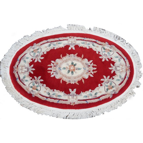 1226 - Four Chinese floral rugs comprising two circular and an oval example, the largest 167cm in diameter