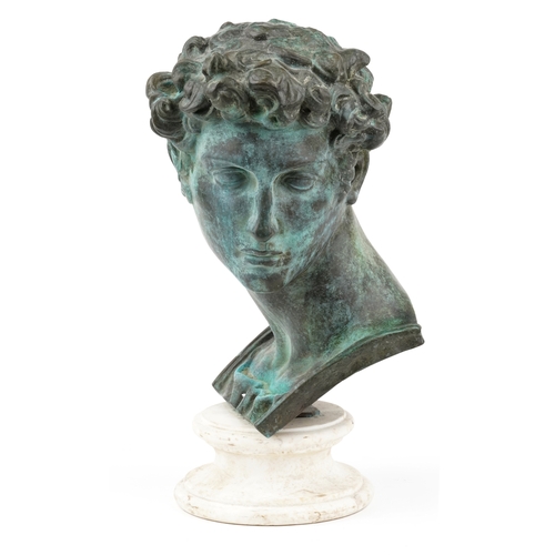 After the Antique, patinated bronze head of David of Michelangelo raised on a circular white alabaster base, 52cm high