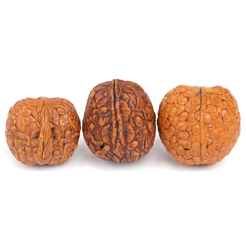 199 - Three Chinese walnuts carved with figures, the largest 4.5cm high