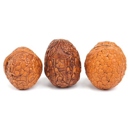 199 - Three Chinese walnuts carved with figures, the largest 4.5cm high