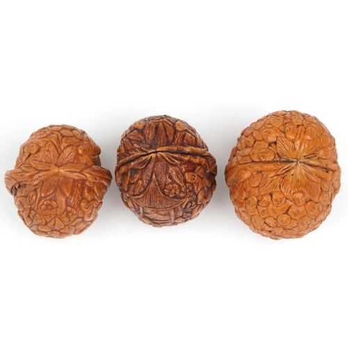 199 - Three Chinese walnuts carved with figures, the largest 4.5cm high