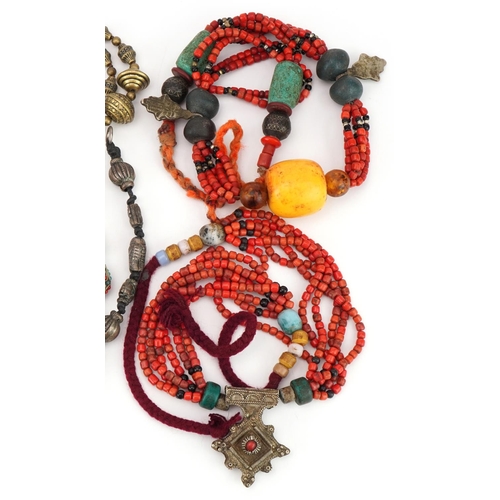 2716 - Five Asian and South American necklaces including amber coloured beads, coral and turquoise, the lar... 