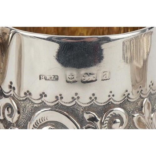 497 - Silver items comprising Victorian floral embossed christening tankard and a floral engraved shell sh... 