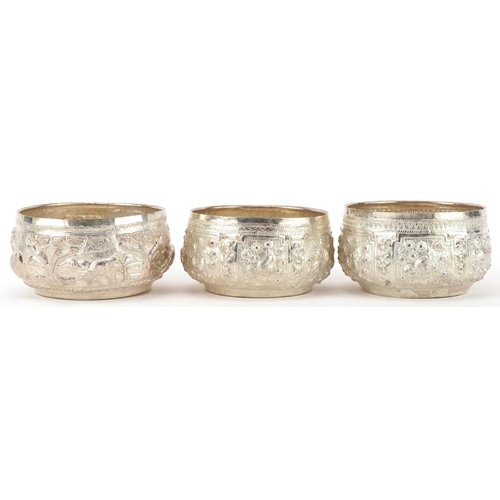 378 - Three Indian silver bowls embossed with wild animals, 10cm in diameter, total 216.2g