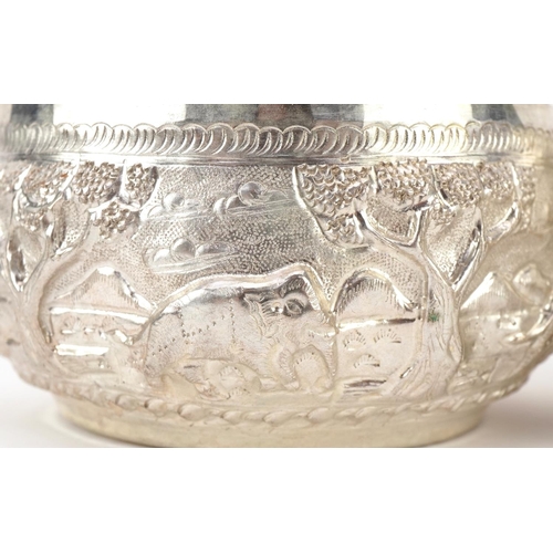 378 - Three Indian silver bowls embossed with wild animals, 10cm in diameter, total 216.2g