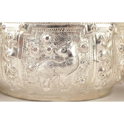 378 - Three Indian silver bowls embossed with wild animals, 10cm in diameter, total 216.2g