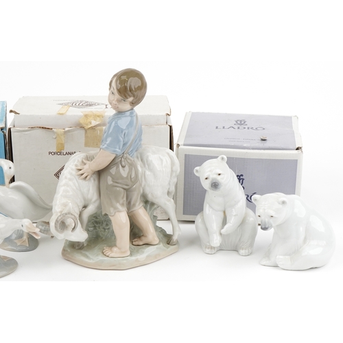 1180 - Nine Lladro and Nao figures, animals and groups including two polar bears and a boy with ram, the la... 