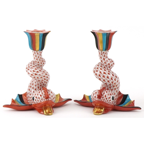 Herend, pair of Hungarian hand painted porcelain fishnet pattern candlesticks in the form of mythical fish, each 14.5cm high