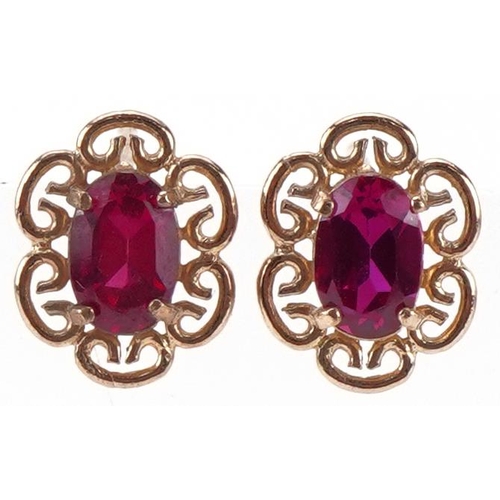 2308 - Pair of 9ct gold ruby stud earrings, each 1cm high, total 1.4g