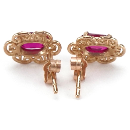 2308 - Pair of 9ct gold ruby stud earrings, each 1cm high, total 1.4g