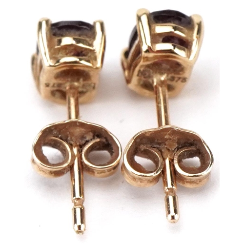 2421 - Pair of 9ct gold garnet stud earrings, each 6mm high, total 0.8g