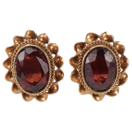 2268 - Pair of 9ct gold garnet stud earrings, each 1.1cm high, total 2.2g