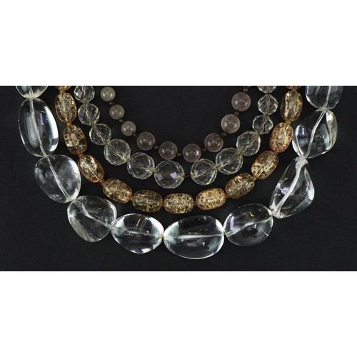 2697 - Four vintage and later necklaces including rock crystal and quartz, one with silver clasp, the large... 