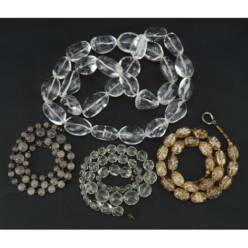 2697 - Four vintage and later necklaces including rock crystal and quartz, one with silver clasp, the large... 